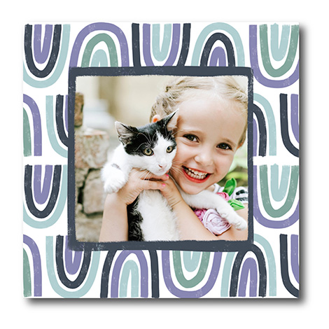 Snapfish Photo Tile of a child holding a kitten with a colourful graphic backdrop